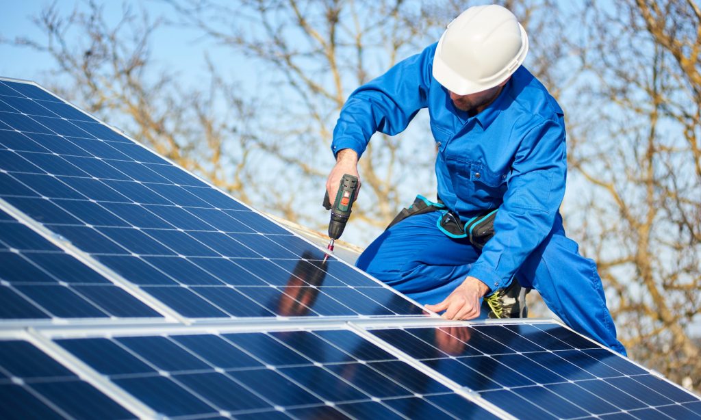 Worker installing solar