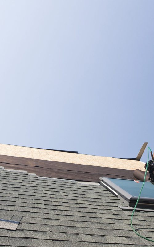 Roofer working on house